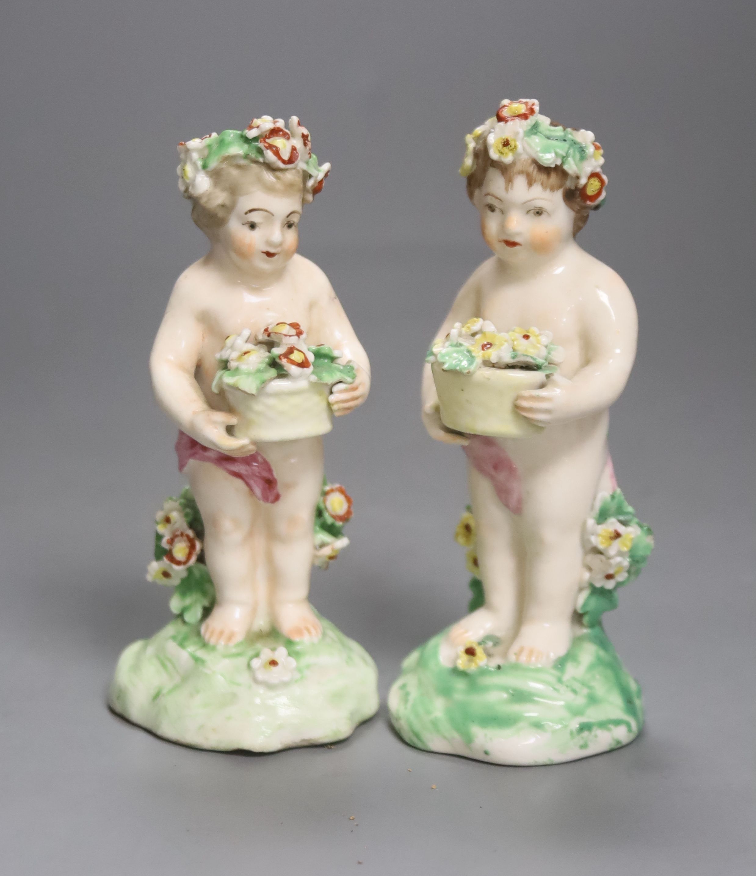 A good pair of Derby figures of children holding baskets of flowers c. 1760, patch marks, firing crack to one arm, height 11.5cm